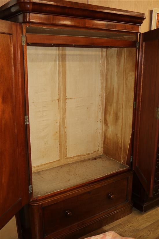 A Victorian mahogany wardrobe, with moulded cornice, fitted two panelled doors and with a drawer below, W.3ft 8in., H.204cm